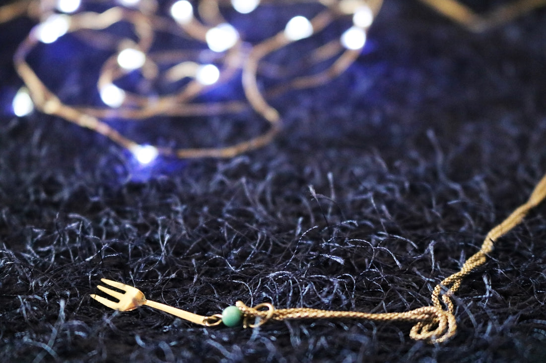 selective focus photography of fork pendant